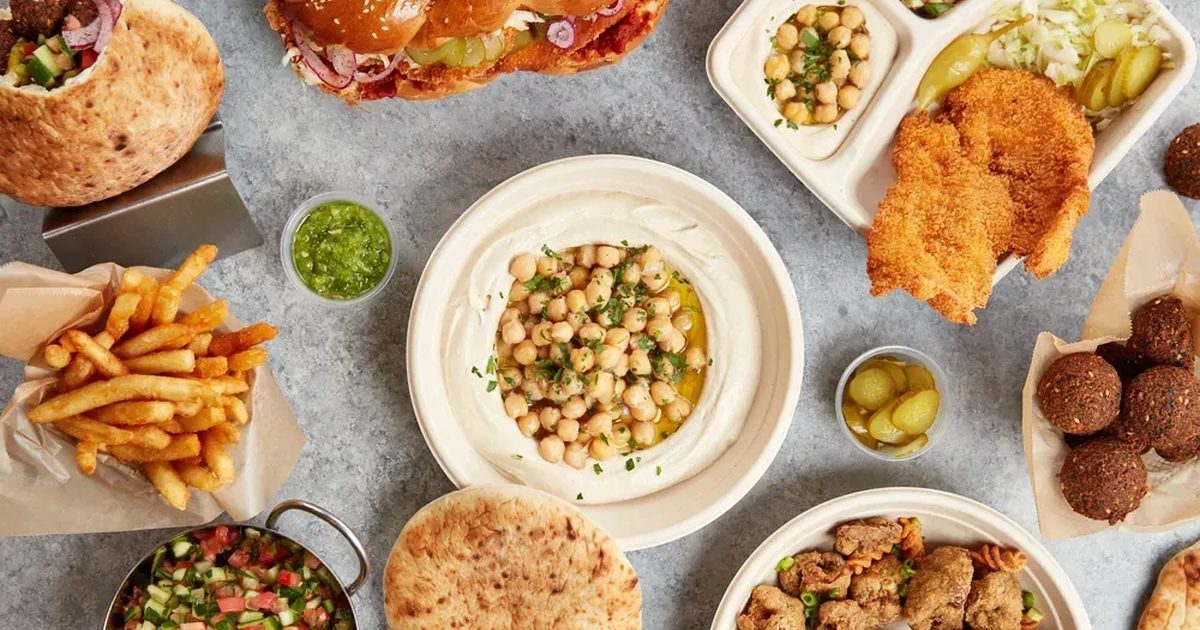 A Hummus Bodega catering spread of trays, dips and salads